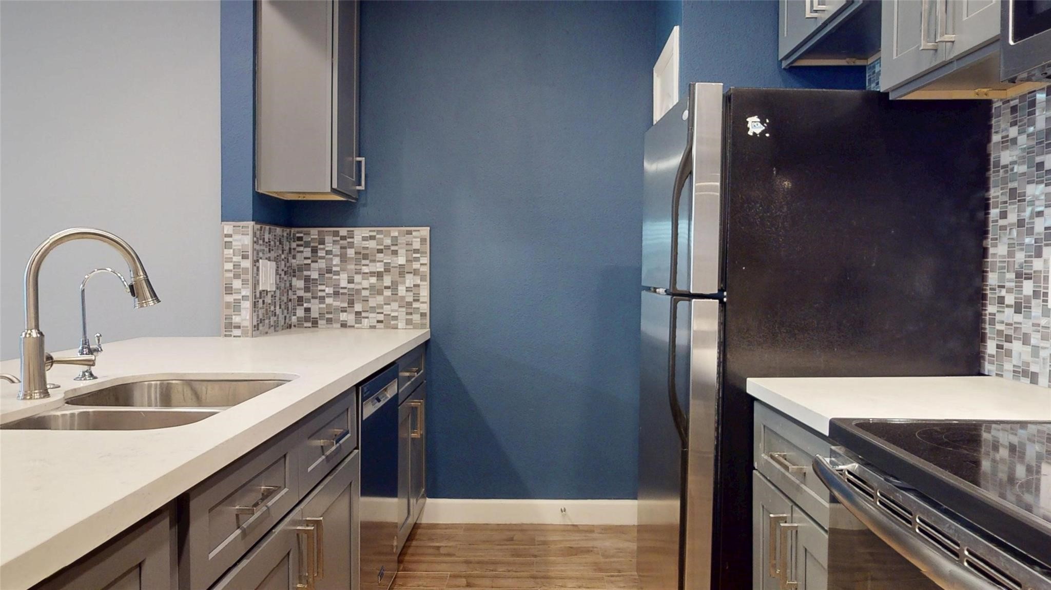 2984 Holly Hall Street Houston, TX 77054 - Photo 7 of 23 a kitchen with stainless steel appliances granite countertop a sink and a refrigerator