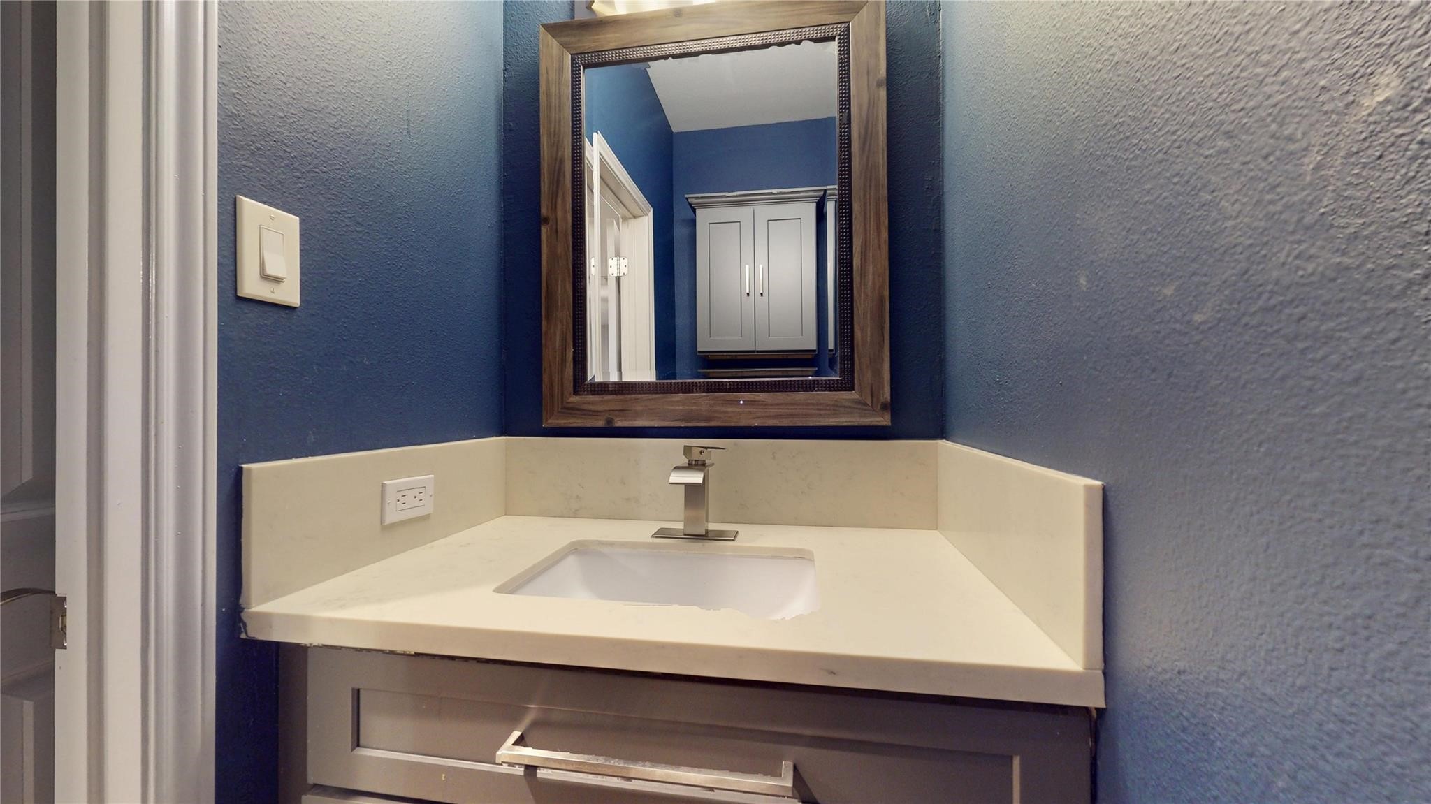 2984 Holly Hall Street Houston, TX 77054 - Photo 9 of 23 a bathroom with a sink and a mirror
