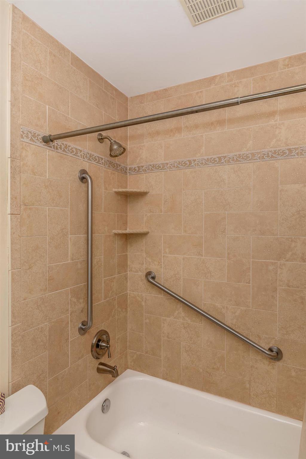7001 Basswood Road Frederick, MD 21703 - Photo 22 of 30 a bathroom with a shower and a bathtub
