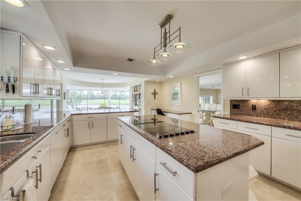 2260 Imperial Golf Course Boulevard Naples, FL 34110 - Photo 11 of 29 a kitchen with stainless steel appliances granite countertop counter space a sink and cabinets