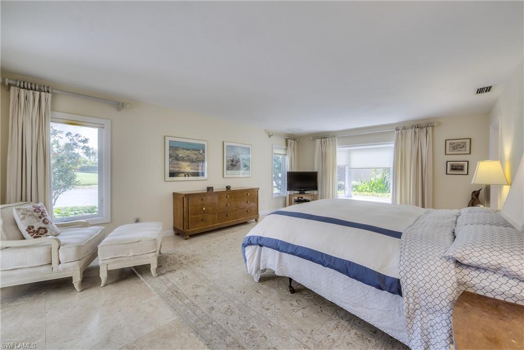 2260 Imperial Golf Course Boulevard Naples, FL 34110 - Photo 14 of 29 a spacious bedroom with a bed and a couch