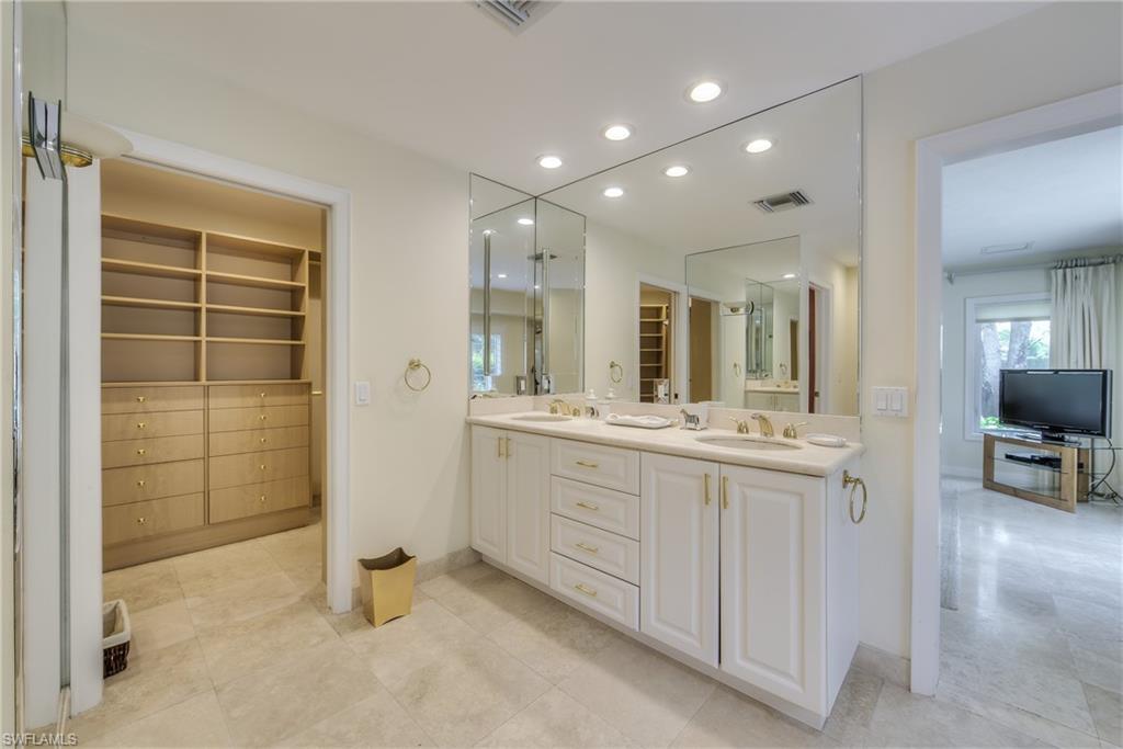 2260 Imperial Golf Course Boulevard Naples, FL 34110 - Photo 18 of 29 a bathroom with a double vanity sink and a mirror