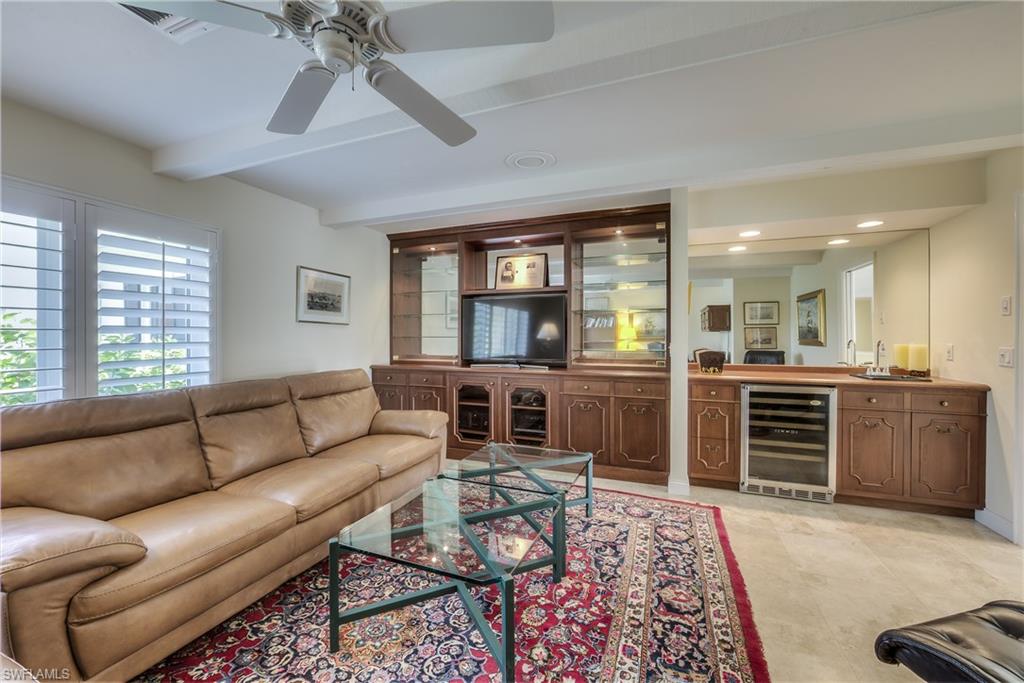 2260 Imperial Golf Course Boulevard Naples, FL 34110 - Photo 21 of 29 a living room with furniture and a open kitchen