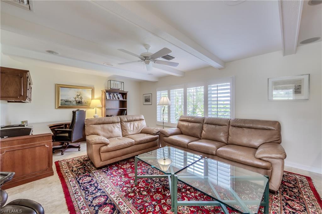 2260 Imperial Golf Course Boulevard Naples, FL 34110 - Photo 22 of 29 a living room with furniture ceiling fan and a rug