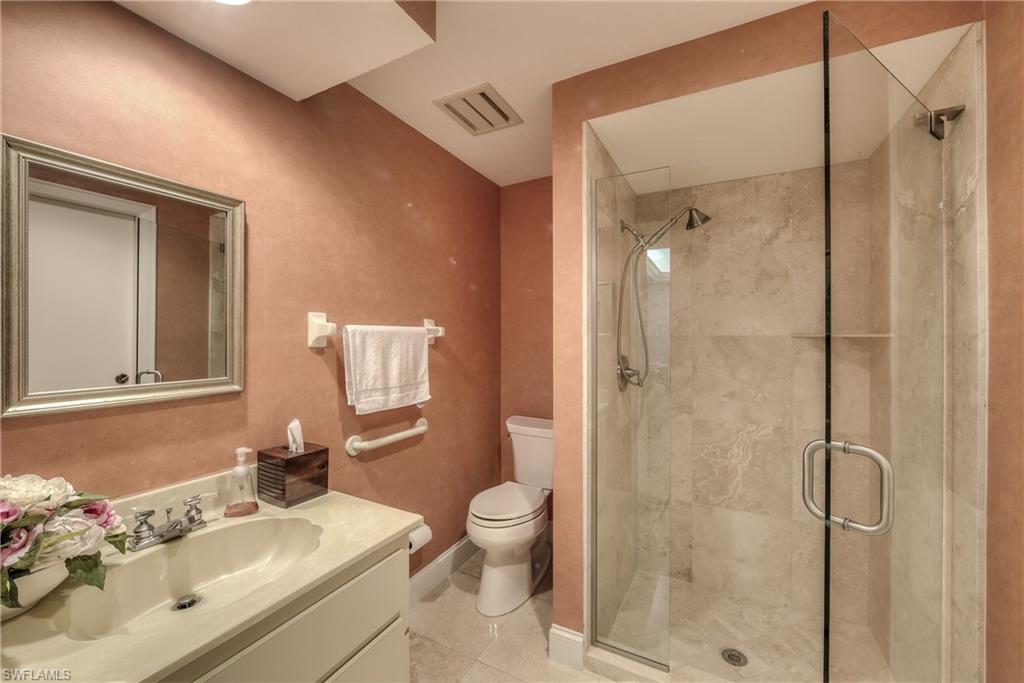 2260 Imperial Golf Course Boulevard Naples, FL 34110 - Photo 23 of 29 a bathroom with a sink a toilet and shower