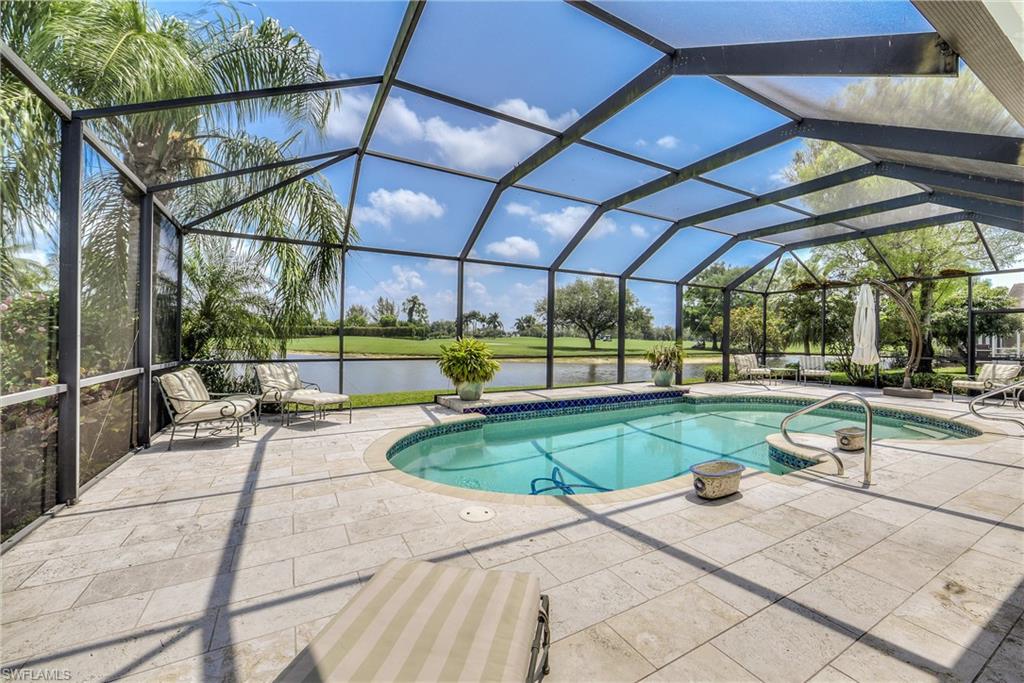 2260 Imperial Golf Course Boulevard Naples, FL 34110 - Photo 24 of 29 a view of a swimming pool with a porch and furniture