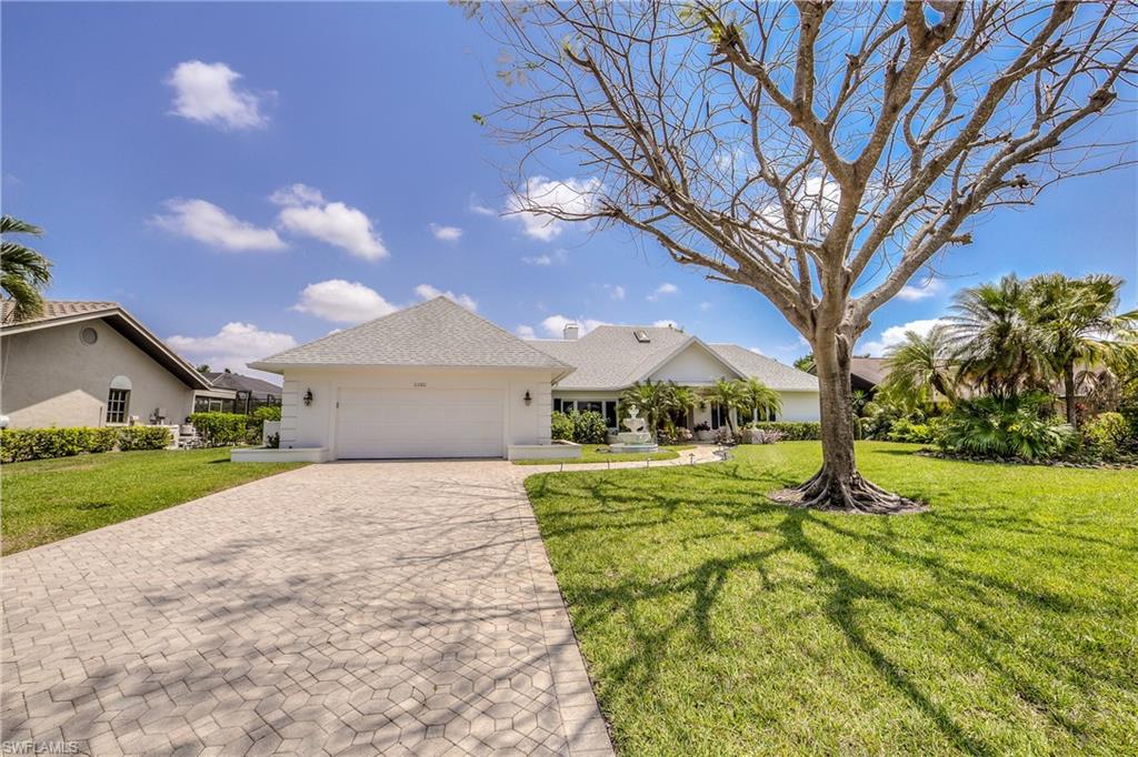 2260 Imperial Golf Course Boulevard Naples, FL 34110 - Photo 29 of 29 a house view with a garden space