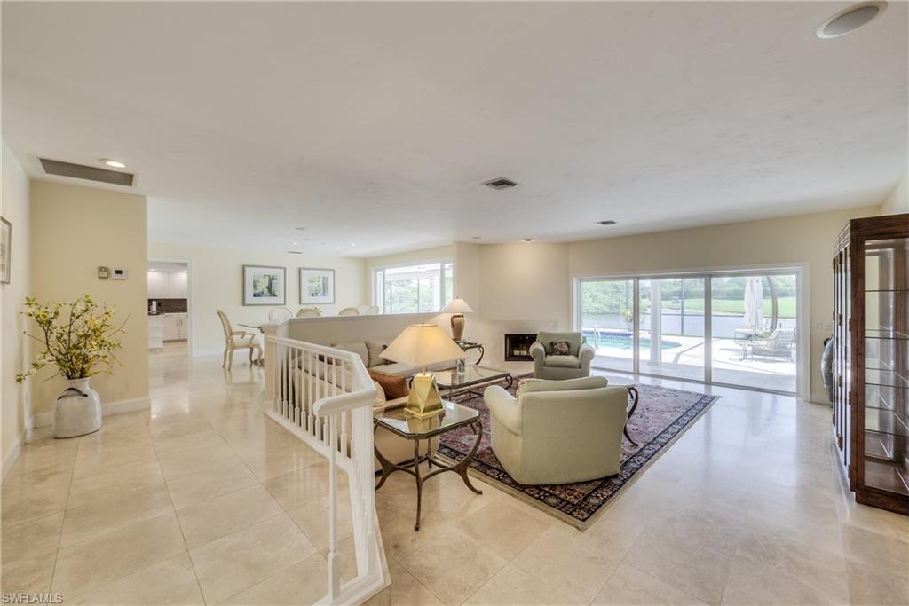 2260 Imperial Golf Course Boulevard Naples, FL 34110 - Photo 5 of 29 a living room with furniture and large windows