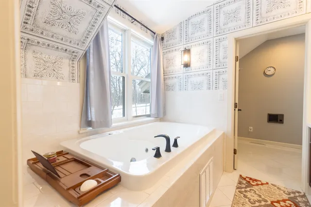 a bath tub sitting next to a window