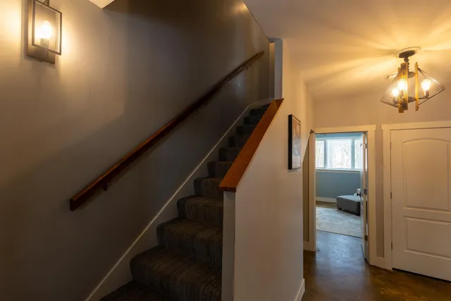 a view of entryway and hall with wooden floor
