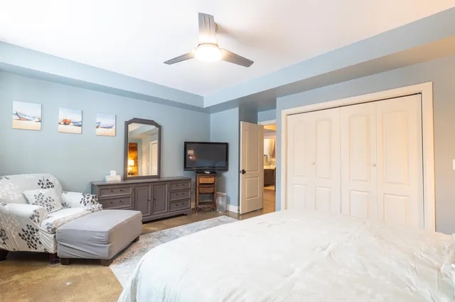 a bedroom with a bed and a television