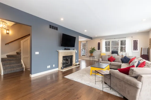 a living room with furniture a fireplace and a flat screen tv