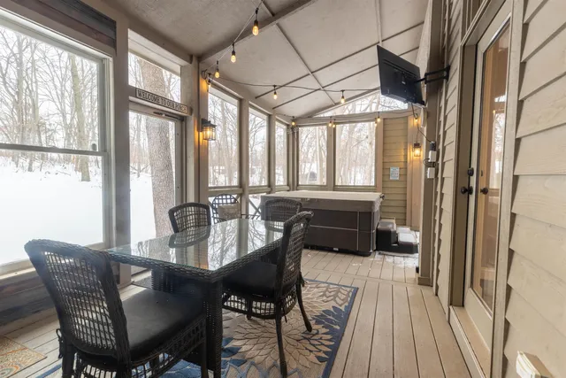a view of a dining room with furniture large windows and wooden floor