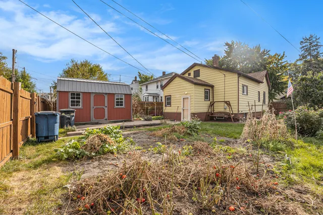a view of a house with a small yard and plants