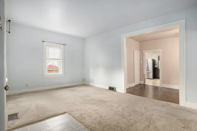 an empty room with windows and entrance