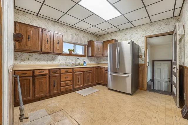 a kitchen with stainless steel appliances granite countertop a refrigerator and a sink