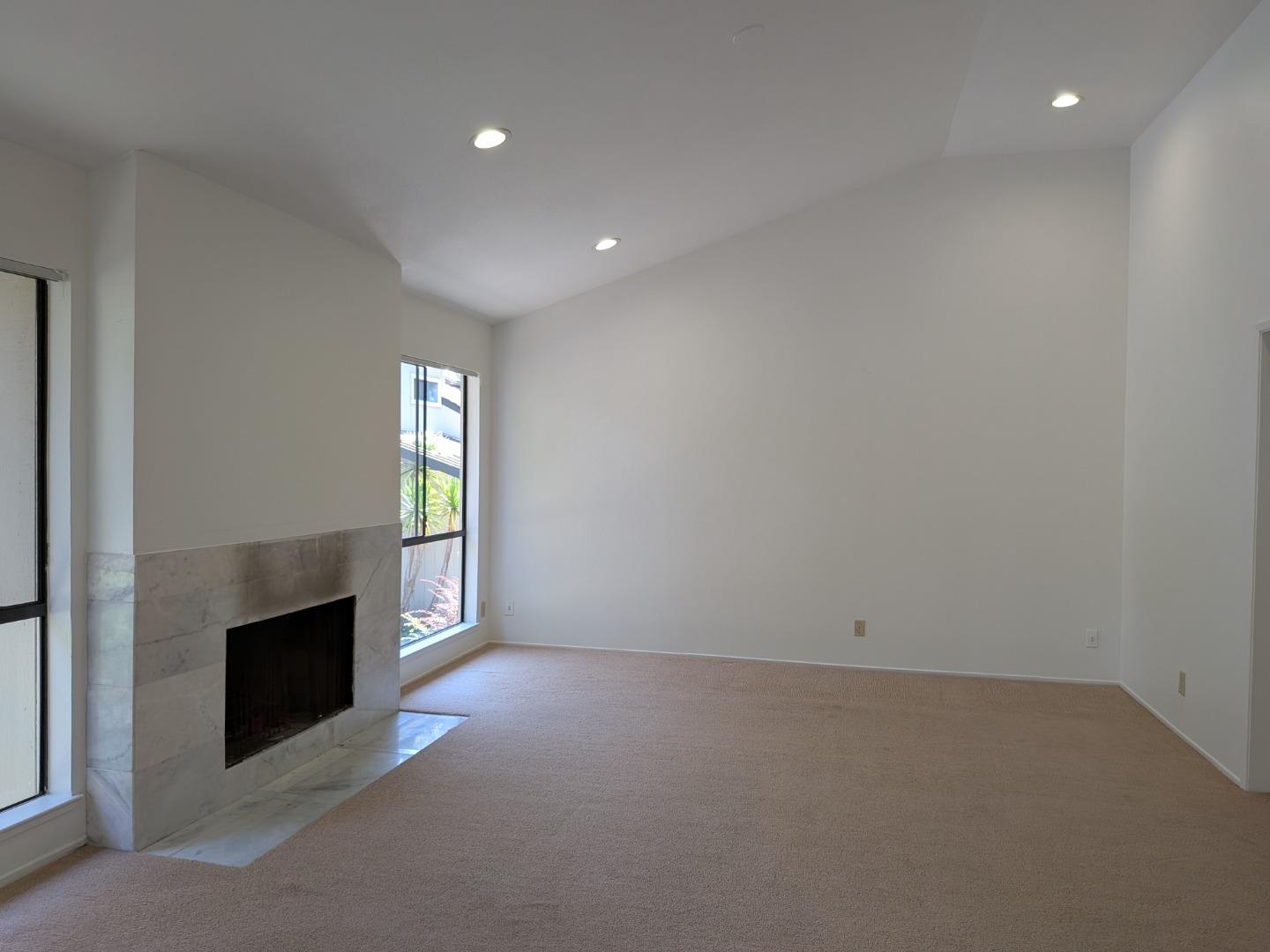 217 Ada Avenue, Unit 45 Mountain View, CA 94043 - Photo 15 of 43 an empty room with windows and fireplace
