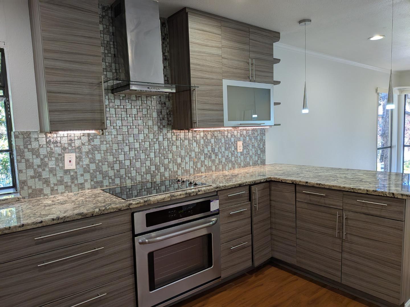 217 Ada Avenue, Unit 45 Mountain View, CA 94043 - Photo 17 of 43 a kitchen with granite countertop cabinets stove and oven