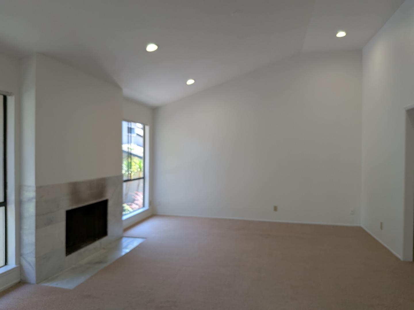 217 Ada Avenue, Unit 45 Mountain View, CA 94043 - Photo 23 of 43 an empty room with windows and fireplace