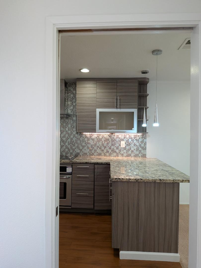 217 Ada Avenue, Unit 45 Mountain View, CA 94043 - Photo 31 of 43 a bathroom with a granite countertop sink and a mirror