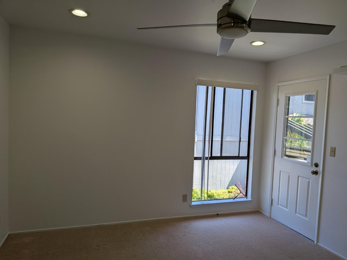 217 Ada Avenue, Unit 45 Mountain View, CA 94043 - Photo 35 of 43 an empty room with windows and ceiling fan