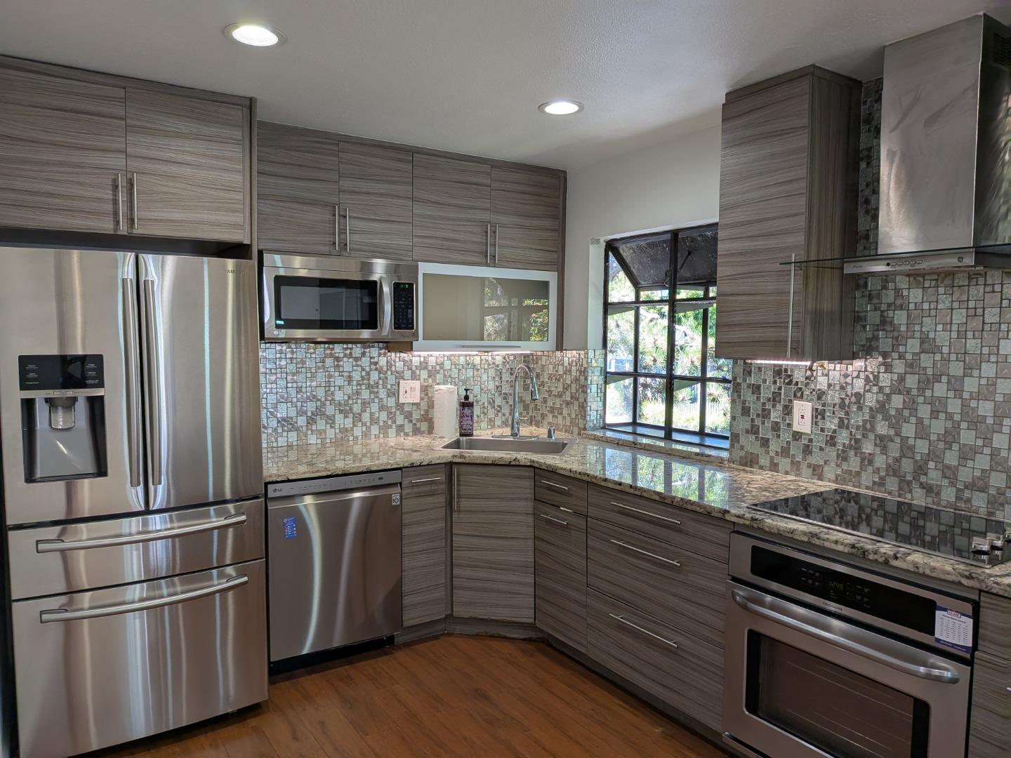 217 Ada Avenue, Unit 45 Mountain View, CA 94043 - Photo 4 of 43 a kitchen with granite countertop stainless steel appliances and wooden cabinets