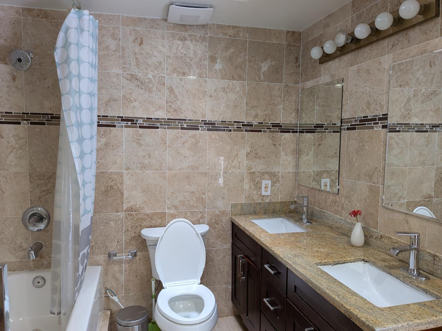 217 Ada Avenue, Unit 45 Mountain View, CA 94043 - Photo 42 of 43 a bathroom with a granite countertop sink mirror vanity and toilet