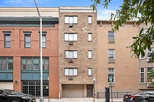 208 1st Street, Unit 5B Hoboken, NJ 07030 - Photo 1 of 11 a front view of a building with a garden and plants