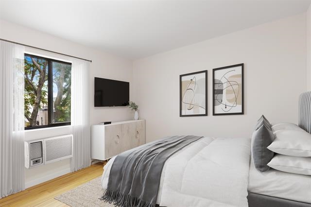 208 1st Street, Unit 5B Hoboken, NJ 07030 - Photo 6 of 11 a bedroom with a bed and a flat screen tv