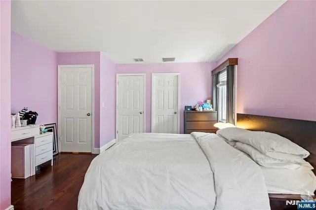 a spacious bedroom with a bed and a closet