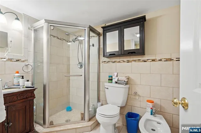 a bathroom with a toilet sink shower and mirror