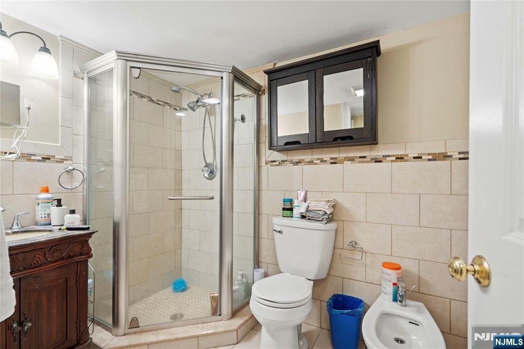 10 East Allendale Road Saddle River, NJ 07458 - Photo 8 of 10 a bathroom with a toilet sink shower and mirror