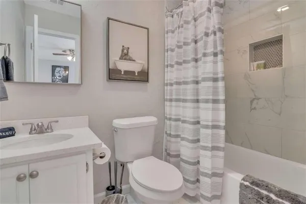 a bathroom with a toilet sink and shower