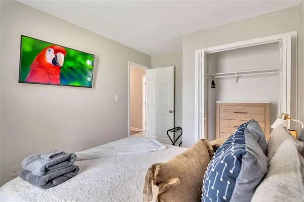 a bed room with a bed and a television