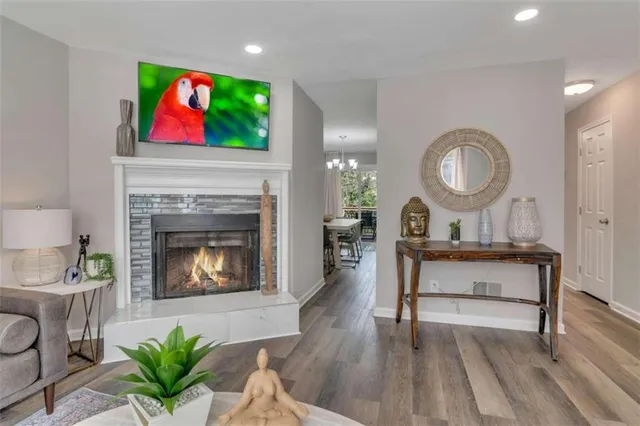 a living room with furniture a fireplace and wall paintings