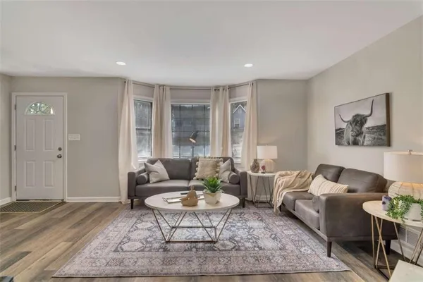 a living room with furniture and a rug