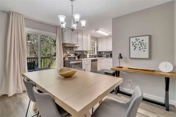 a kitchen with a table a stove and cabinets