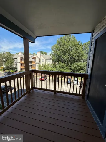 a view of a balcony with wooden floor