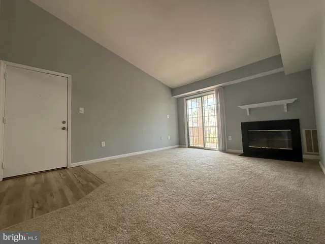 a view of empty room with a fireplace