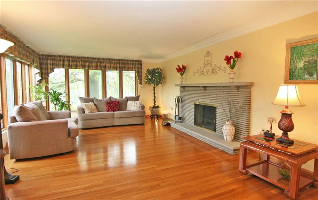 105 Center Church Road Canonsburg, PA 15317 - Photo 6 of 25 WOW!...Gleaming hardwood floor, custom wall paint, crown molding, walls of windows, cozy stone fireplace....Does It get any better than this?