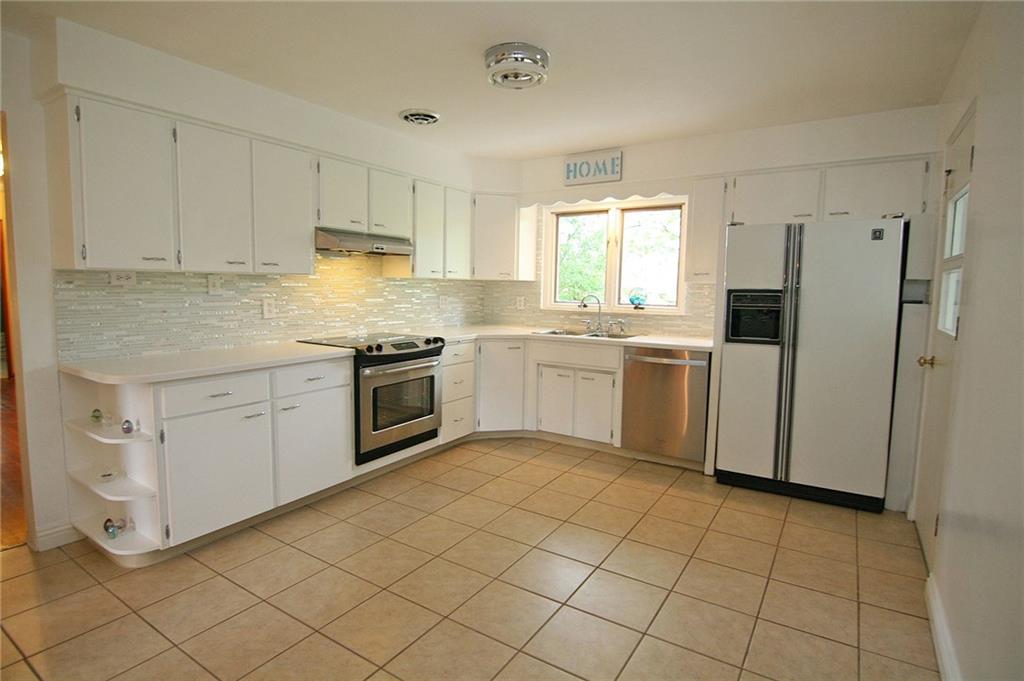 105 Center Church Road Canonsburg, PA 15317 - Photo 9 of 25 Spacious, updated eat-in kitchen with an abundance of cabinet and counter space, solid surface countertops, ceramic tile floor...and plenty of room for your table and chairs!
