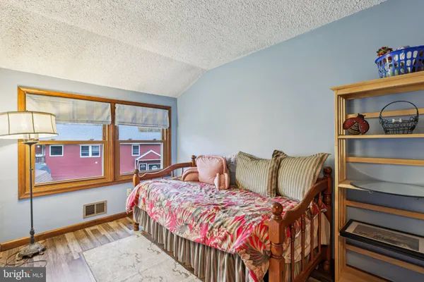 a bedroom with a bed and a table