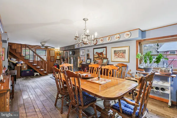 a dining room with lots of wooden furniture and wooden floor