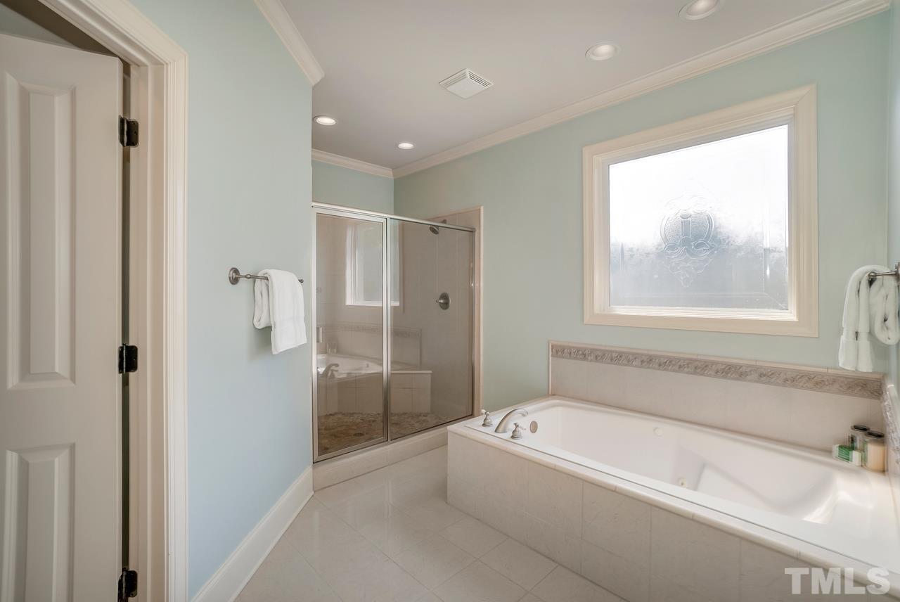 248 Waterville Street Raleigh, NC 27603 - Photo 15 of 30 a bathroom with a bathtub and a shower