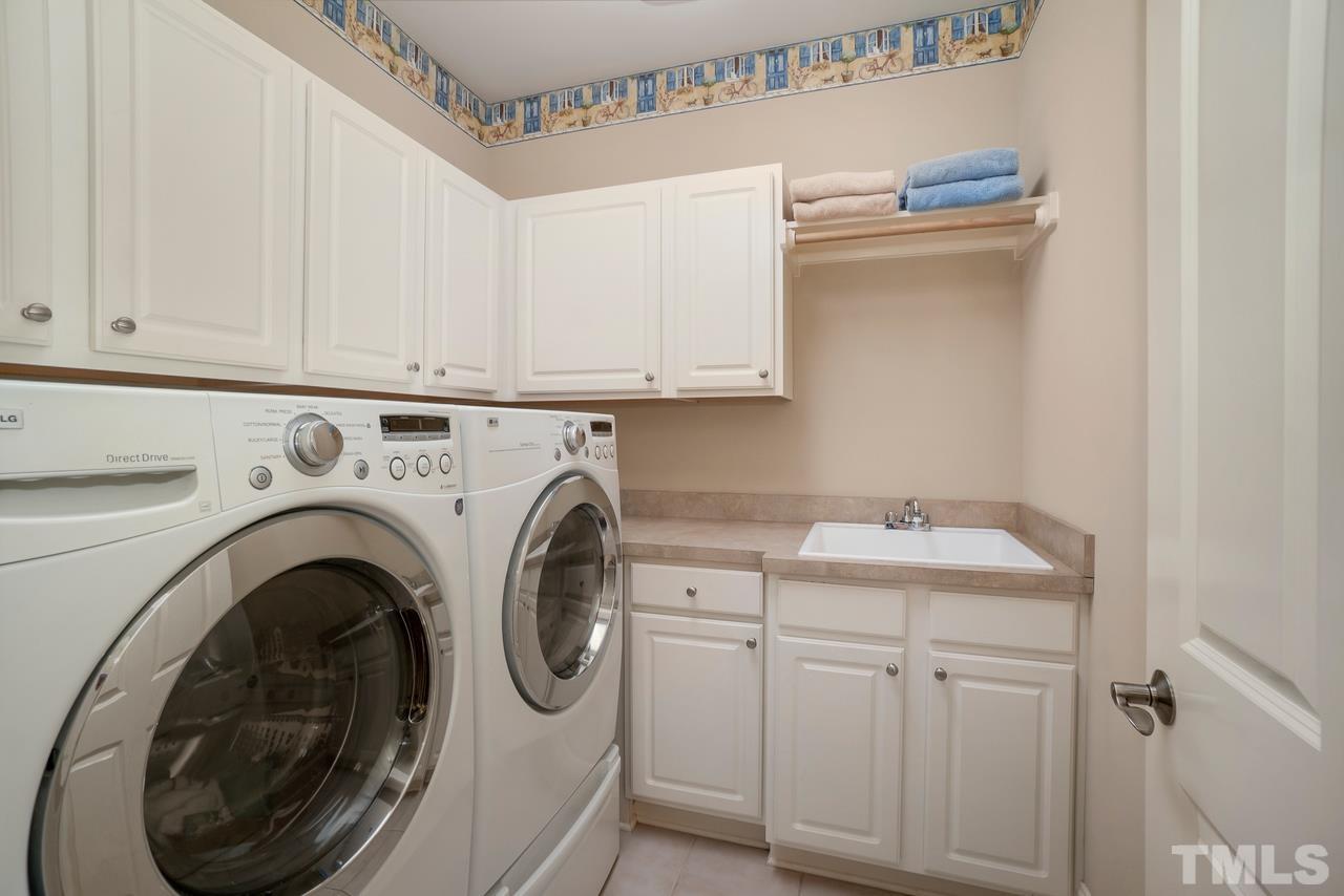 248 Waterville Street Raleigh, NC 27603 - Photo 18 of 30 a utility room with sink dryer and washer