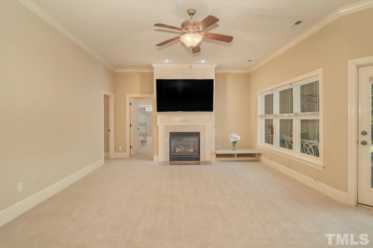 248 Waterville Street Raleigh, NC 27603 - Photo 20 of 30 a view of a livingroom with a fireplace and a flat screen tv