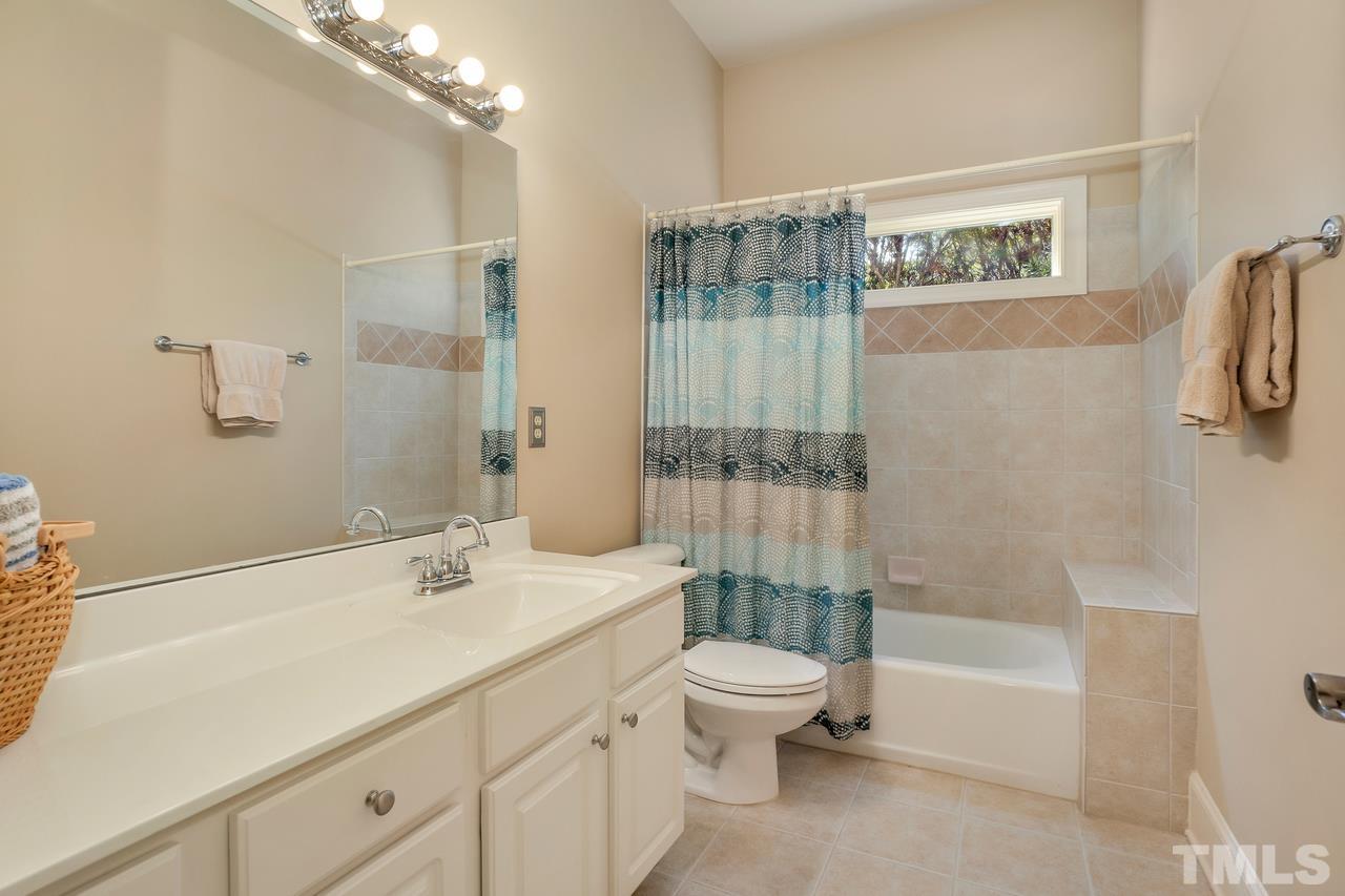 248 Waterville Street Raleigh, NC 27603 - Photo 24 of 30 a bathroom with a sink a toilet and shower