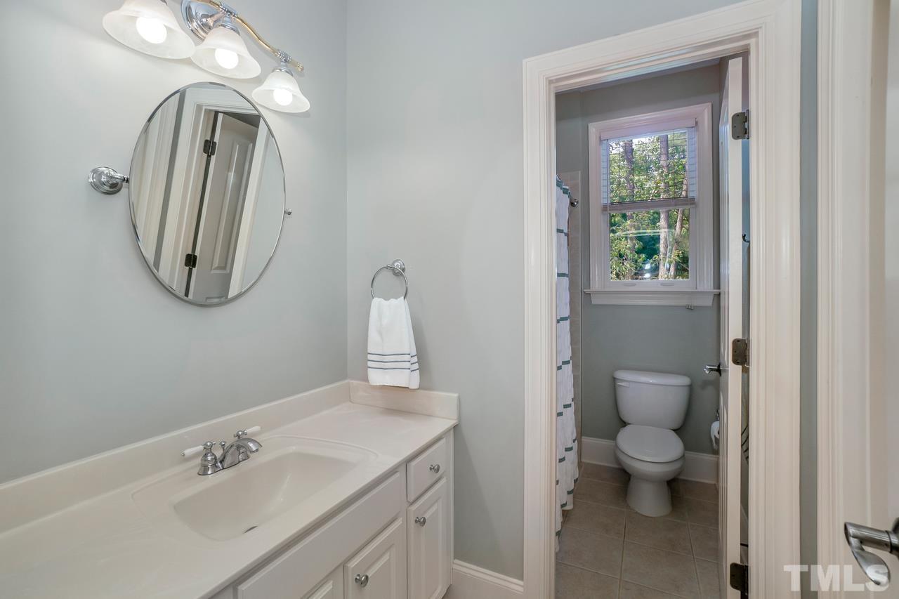 248 Waterville Street Raleigh, NC 27603 - Photo 26 of 30 a bathroom with a toilet sink and mirror