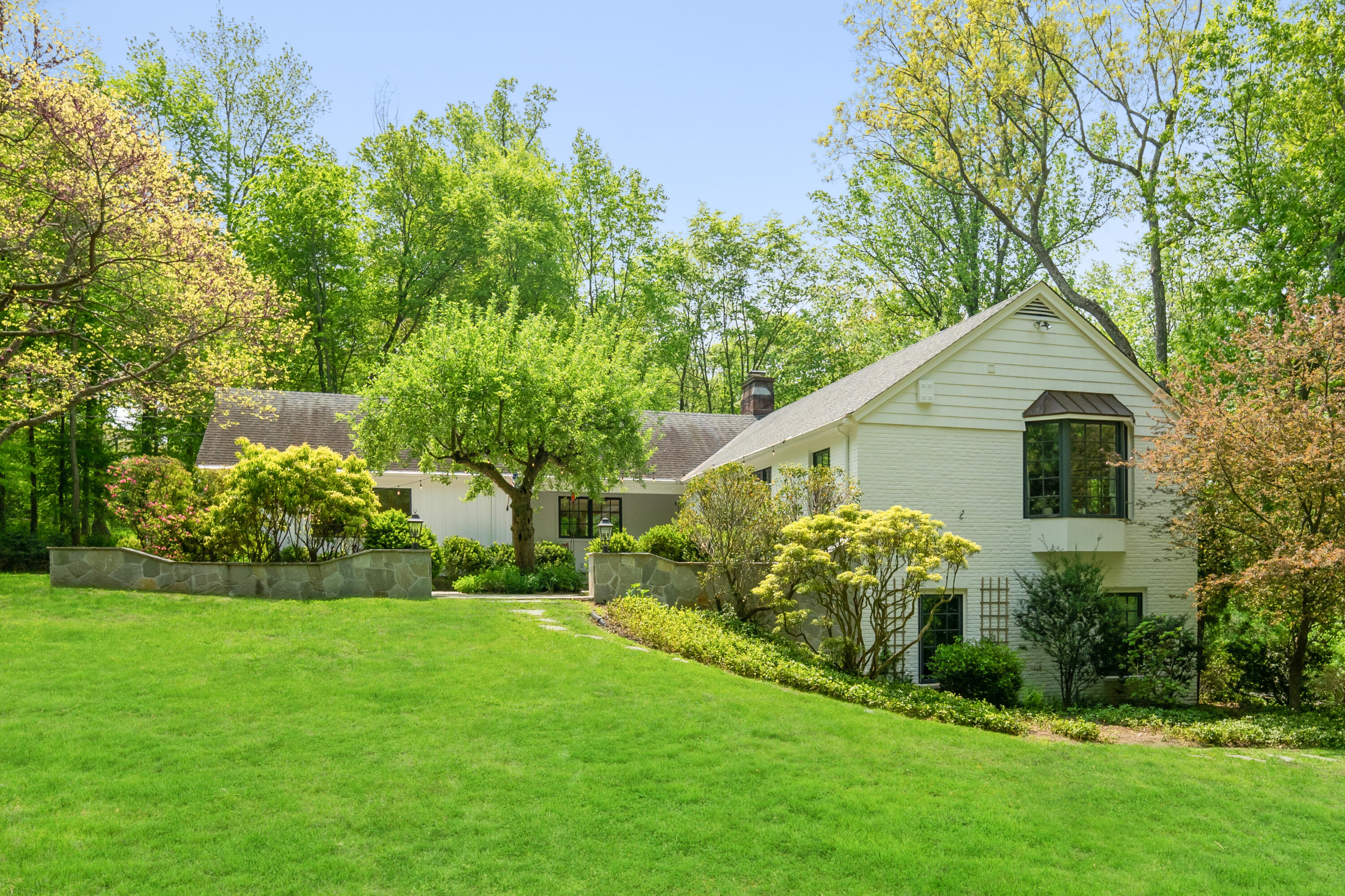 86 Logan Road New Canaan, CT 06840 - Photo 3 of 38 a front view of house with garden