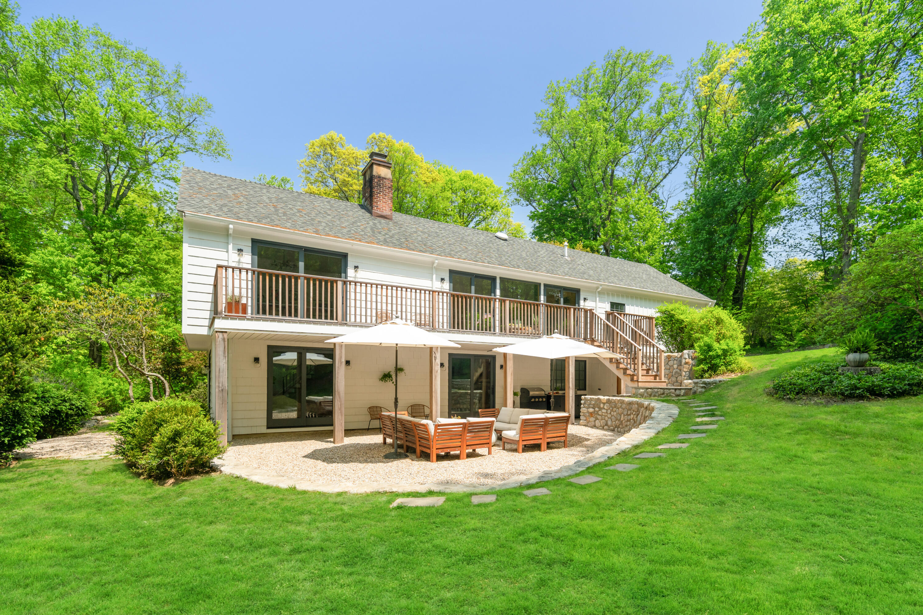 86 Logan Road New Canaan, CT 06840 - Photo 4 of 38 a view of a house with backyard sitting area and garden
